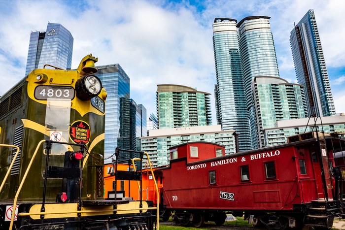 Colourful railway engines against a city skyline